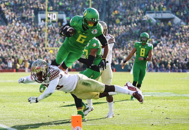 Oregon wide receiver Charles Nelson (6) scores over Florida State defensive back Nate Andrews. The Ducks advance to the first college football playoff championship in Arlington, Texas, on Jan. 12. (AP Photo/Doug Benc)