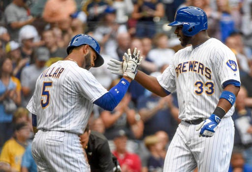 Milwaukee Brewers' Chris Carter, right, is greeted by Jonathan Villar after hitting a two-run home run during the first inning of a baseball game against the Pittsburgh Pirates on Friday, July 29, 2016, in Milwaukee. (AP Photo/Benny Sieu)