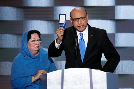Khizr Khan, father of fallen US Army Capt. Humayun S. M. Khan holds up a copy of the Constitution of the United States as his wife listens during the final day of the Democratic National Convention in Philadelphia , Thursday, July 28, 2016. (AP Photo/J. Scott Applewhite)