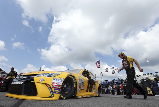 Kyle Busch (18) drives in the garage area at Pocono Raceway during practice for Sunday's NASCAR Sprint Cup Series Pennsylvania 400 auto race Sunday on Friday in Long Pond, Pa. (AP Photo/Mel Evans)