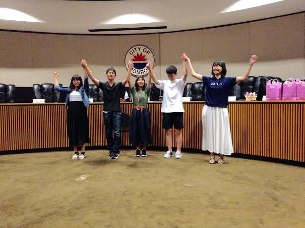 The high school students who are visiting from Hofu, Japan, take a bow after performing their skit July 27 at Monroe City Hall (Monroe News photo by PAULA WETHINGTON)