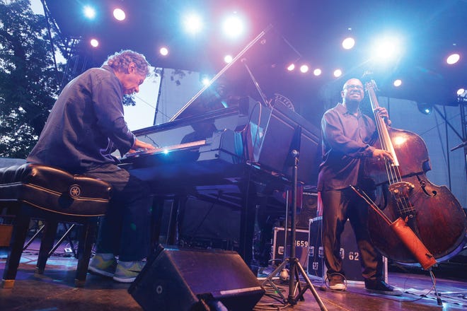 Chick Corea on piano, Christian McBride on bass along with Brian Blade, not shown, on drums play at the International Tennis Hall of Fame in Newport on Friday, the opening day of the Newport Jazz Festival.