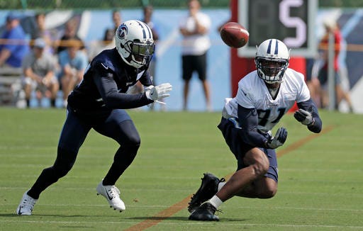 Tennessee Titans wide receiver Andre Johnson (81) catches a pass as he is defended by cornerback Antwon Blake during NFL football training camp Saturday, July 30, 2016, in Nashville, Tenn. Johnson signed with the team Friday. (AP Photo/Mark Humphrey)