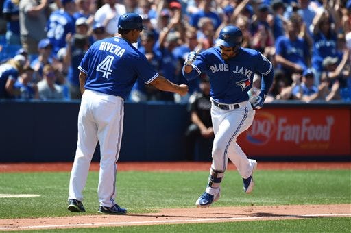 Toronto Blue Jays' Devon Travis rounds third base after hitting a solo home run during the fifth inning of a baseball game, in Toronto on Saturday, July 30, 2016. (Jon Blacker/The Canadian Press via AP)