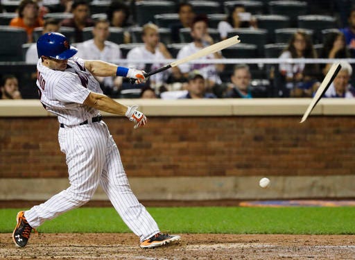 New York Mets' Travis d'Arnaud breaks his bat while hitting a single during the eighth inning of a baseball game against the Colorado Rockies, Friday, July 29, 2016, in New York. (AP Photo/Frank Franklin II)