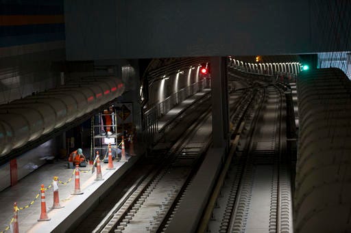FILE - In this July 7, 2016 file photo, Odebrecht personnel work on the Line 4 of the subway that is under construction in Rio de Janeiro, Brazil. Brazilian officials held a ribbon-cutting ceremony Saturday, July 30, 2016, for a much-delayed $3 billion subway expansion in Rio de Janeiro less than a week before the Olympic Games begin. Line 4 of the subway is billed as Rio’s most important infrastructure project linked to the Olympics. It will transport hundreds of thousands of athletes and fans between the city’s iconic beaches and Barra da Tijuca, home to most sporting venues. (AP Photo/Silvia Izquierdo, File)