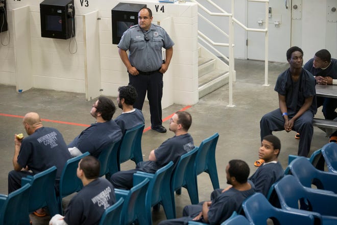 Corrections Officer Eligio Rivas watches over inmates in housing unit 3F Wednesday, July 29, 2015, at the Winnebago County Jail in Rockford. RRSTAR.COM FILE PHOTO