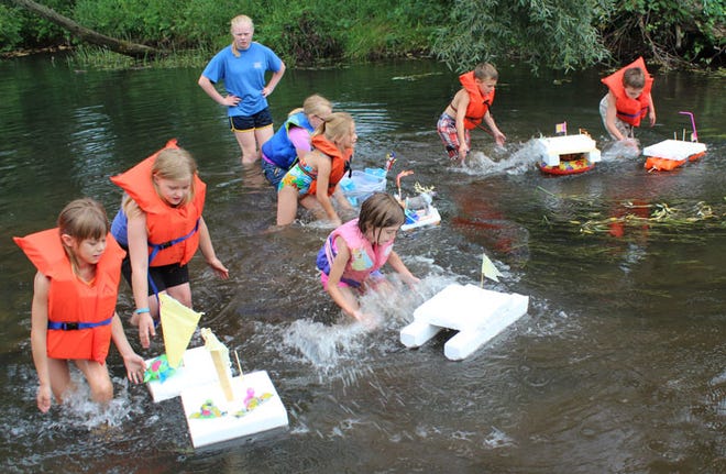 Participants in the intermediate age group start the race Friday on Prairie River during the “Floatable Boatable” competition, part of Burr Oak Heritage Days. Each child made his or her own boat.