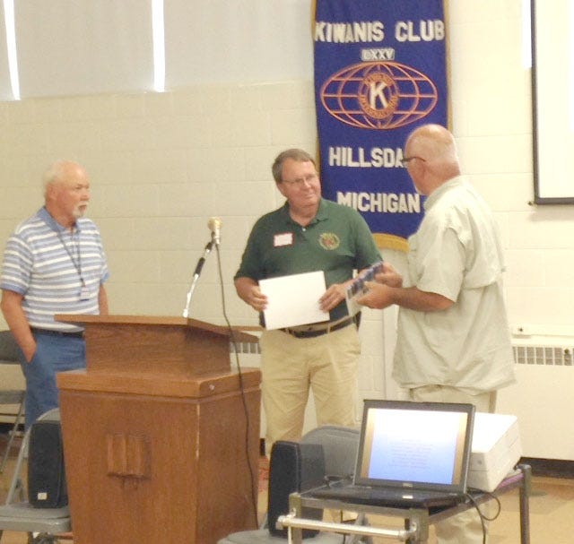 Doug Sanford, director of the Hillsdale County 911 (center) recently spoke at the Hillsdale Kiwanis meeting. COURTESY PHOTO