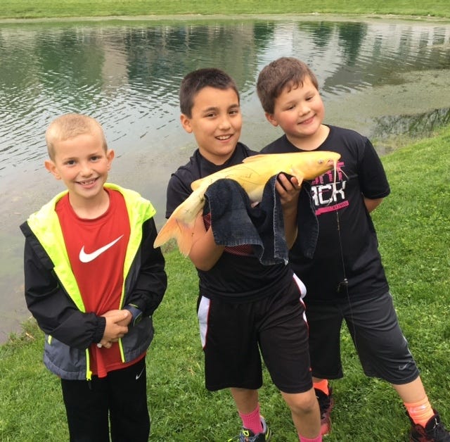 Collin VonKaenel — with his friends — caught an albino catfish at Grove City in his own backyard pond. Beth VonKaenel submitted the photo.