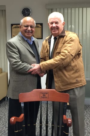 Cummings Properties founder Bill Cummings, right, presents a 20-year chair to Scientific Systems Company CEO Rahman Mehra, of Lexington. Courtesy Photo