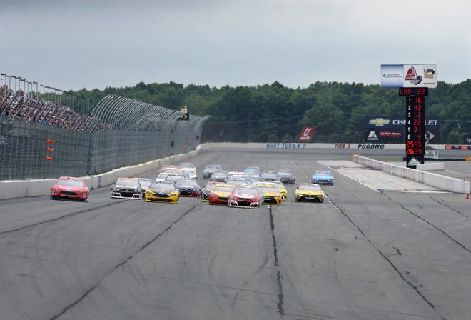 Race cars spread across the track during a restart of the NASCAR Sprint Cup Series Pennsylvania 400 auto race at Pocono Raceway, Monday, Aug. 1, 2016, in Long Pond, Pa. (AP Photo/Mel Evans)