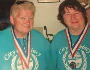 The late Barbara Perry, 71, and her friend Gracie Raymondi, both of the Germantown neighborhood in Quincy, with their Quincy Senior Olympic medals from past games.