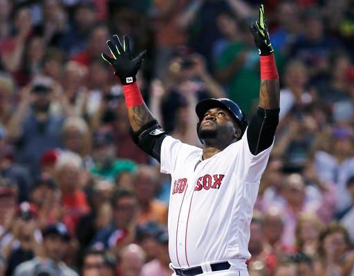 Boston Red Sox designated hitter David Ortiz raises his arms as he crosses home plate on his three-run home run against the Detroit Tigers at Fenway Park last Tuesday in Boston.