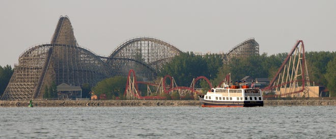 FILE - In this June 2, 2009, file photo, the Goodtime I boat passes the Maverick and Mean Streak roller coasters while coasting by the Cedar Point shoreline in Sandusky, Ohio. Cedar Point announced on August 1, 2016 that it would close Mean Streak permanently on September 16, 2016. (Jason Werling/Sandusky Register via AP, File)