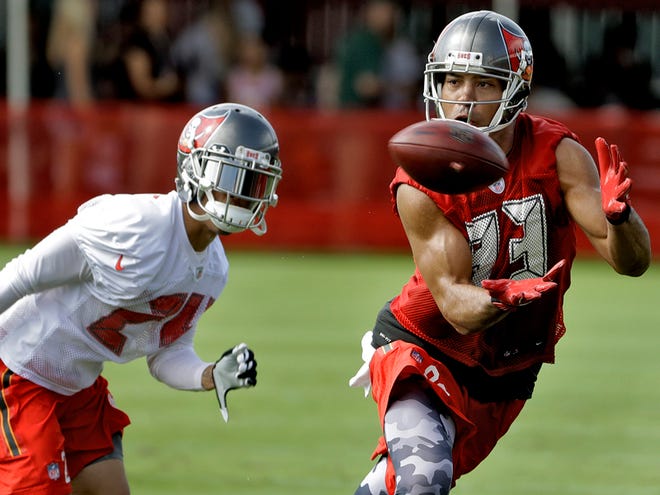 Tampa Bay Buccaneers wide receiver Vincent Jackson (83) makes a catch in front of cornerback Brent Grimes (24) during an NFL football teams training camp practice Friday, July 29, 2016, in Tampa.