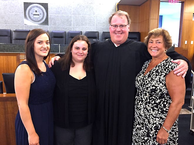 Bucks County Judge Jeffrey G. Trauger on Tuesday, Aug. 2, 2016, stands with his wife, Colleen Trauger (right), and daughters Rebecca (left) and Rachel following the judge's swearing-in ceremony.