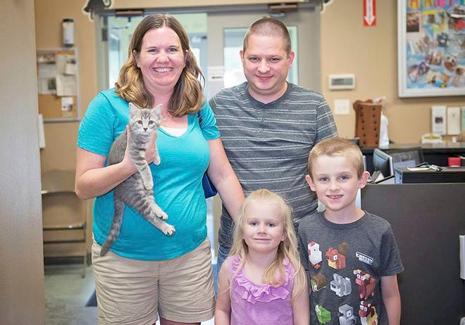 The French family of Boone was one of the families who adopted a new pet from the Boone Area Humane Society Saturday during the Clear the Shelters event. Pictured are, from left, Nadene and Fred French, with their children Kaitlyn and Ben.