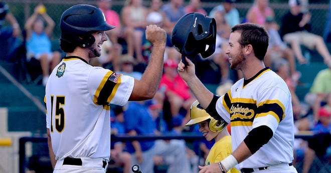 Leesburg's Tanner Long, left, greets teammate Josh Pagliei after Pagliei scored a run in a playoff game at Pat Thomas Stadium-Buddy Lowe Field on Tuesday in Leesburg. The Lightning beat the Winter Garden Squeeze 2-1 in 11 innings. (Amber Riccinto/ Daily Commercial)