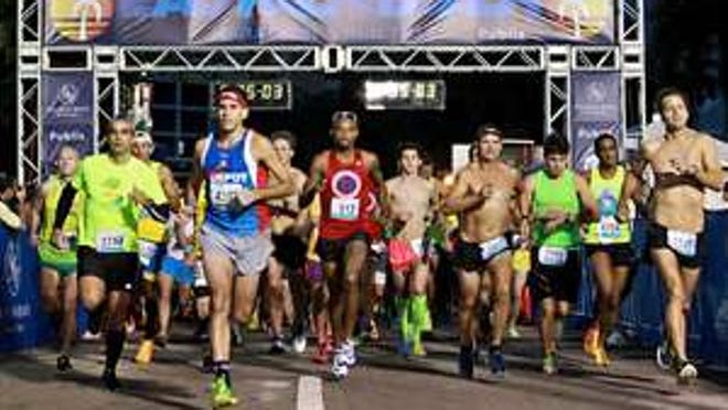 Runners start the 12th annual Eau Palm Beach Marathon in downtown West Palm Beach on December 6, 2015. (Richard Graulich / The Palm Beach Post)