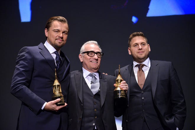 FILE - In this Feb, 6, 2014, file photo, Leonardo DiCaprio, Martin Scorsese, and Jonah Hill are seen onstage at 2014 Santa Barbara International Film Festival - Cinema Vanguard Award ceremony in Santa Barbara, Calif. A video posted online by E! on August 2, 2016, shows DiCaprio pranking Hill on a New York City street. (Photo by Richard Shotwell/Invision/AP, File)