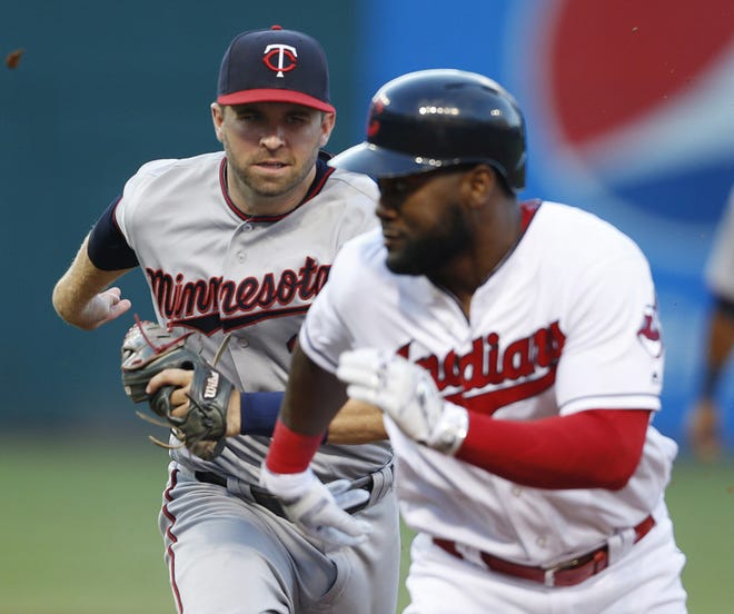 Minnesota Twins' Brian Dozier chases down Cleveland Indians' Abraham Almonte in a rundown between first and second bases during the second inning Wednesday in Cleveland. Dozier made the tag for the out. (AP Photo/Ron Schwane)
