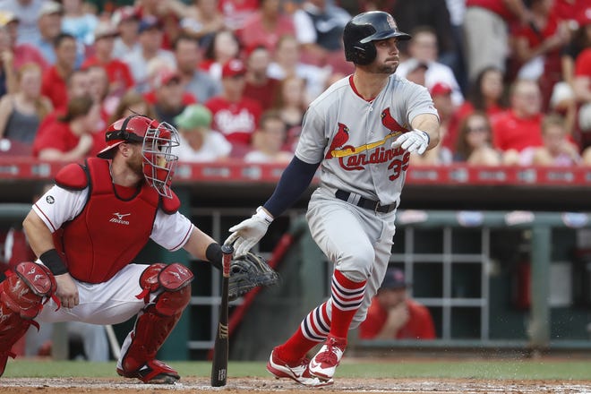 St. Louis Cardinals' Greg Garcia watches his two-run single off Cincinnati Reds starting pitcher Cody Reed during the first inning of Wednesday's game in Cincinnati. (AP Photo/John Minchillo)