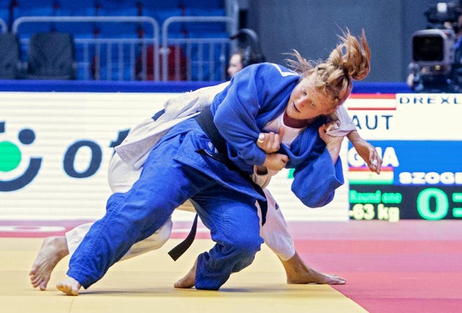 In this handout picture taken in August 2014, Ghana's Szandra Szogedi, front, competes against Austria's Hilde Drexler during the Judo World Championships in Chelyabinsk, Russia. When Hungarian native Szandra Szogedi steps onto the judo mat at the Rio de Janeiro Olympics she'll be making history as the first-ever female judoka to represent Ghana. The opening ceremony for the Olympics takes place on Friday, Aug. 5, 2016. (Rafal Burza/International Judo Federation via AP)