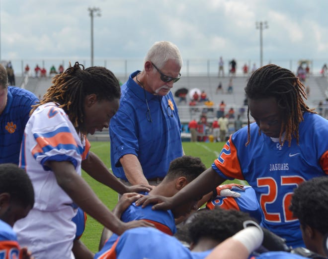 Cedar Shoals' head coach Scott Wilkins prays with team members before Clarke Central takes on Cedar Shoals at Cedar Shoals High School on Saturda, Sept. 13, 2014 in Athens, Ga.  
(Richard Hamm/Staff) OnlineAthens / Athens Banner-Herald