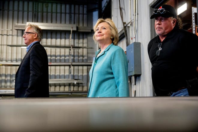 Democratic presidential candidate Hillary Clinton, accompanied by Southern Nevada Chapter of the National Electrical Contractors Association Executive Director Donald Campbell, left, and Mojave Electric Supervisor Jackson Renner, tours the Mojave Electric Company in Las Vegas, Thursday. (AP Photo/Andrew Harnik)