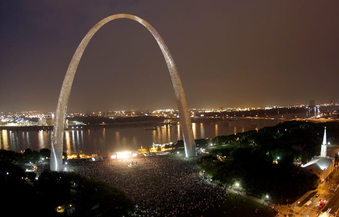 FILE - In this July 11, 2009, file photo thousands watch a concert by Sheryl Crow under the Gateway Arch in St. Louis. Video shows a mysterious light appearing high over the arch on August 2, 2016. (AP Photo/Jeff Roberson, File)