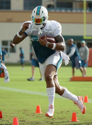 Miami Dolphins running back Arian Foster runs drills during training camp on Monday in Davie.