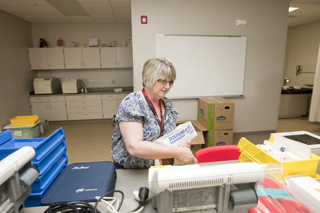 Health Professions Professor Debbie Shaffer unpacks in her new and much improved classroom Thursday, Aug. 4, 2016 at the new Health Professions Building on the SCC campus in West Burlington, IA. Maintenance workers and teachers alike are putting the finishing touches on the new building and will be ready for students to begin classes on August 24.