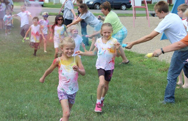 Children have fun as they are sprayed by different colors of powder during the fun run. COURTESY PHOTO