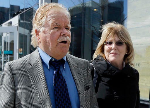 Robert Fitzpatrick, of Charlestown, R.I., walks from federal court in Boston with his wife Jane on April 30, 2015. Fitzpatrick, a former FBI agent accused of lying during his testimony in the trial of Boston gangster James "Whitey" Bulger, pleaded guilty to perjury and obstruction of justice for lying and overstating his professional accomplishments.