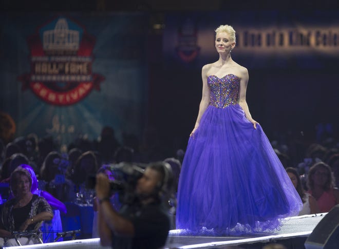 A vision in purple. A model shows off a gown at the Pro Football Hall of Fame Enshrinement Festival Fashion Show. (CantonRep.com / Bob Rossiter)