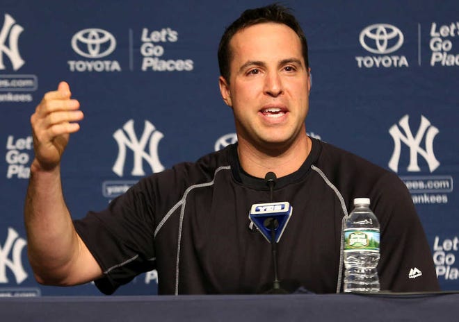 New York Yankees first baseman Mark Teixeira announces his plans to retire at the end of the season to reporters before a game on Friday in New York.