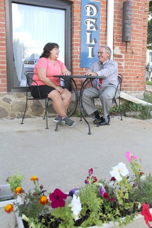 Hillsdale Business Association president Cindy Bieszk and Randy Yagiela, Hillsdale County Chamber of Commerce executive director talk out in front of the Hillsdale Filling Station Deli. ANDY BARRAND PHOTO