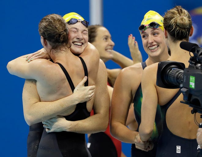 Australia's Emma McKeon, Brittany Elmslie, Bronte Campbell and Cate Campbell celebrate after winning the gold medal and setting a new world record in the women's 4x100-meter freestyle final during the swimming competitions at the 2016 Summer Olympics, Saturday, Aug. 6, 2016, in Rio de Janeiro, Brazil. (AP Photo/David J. Phillip )