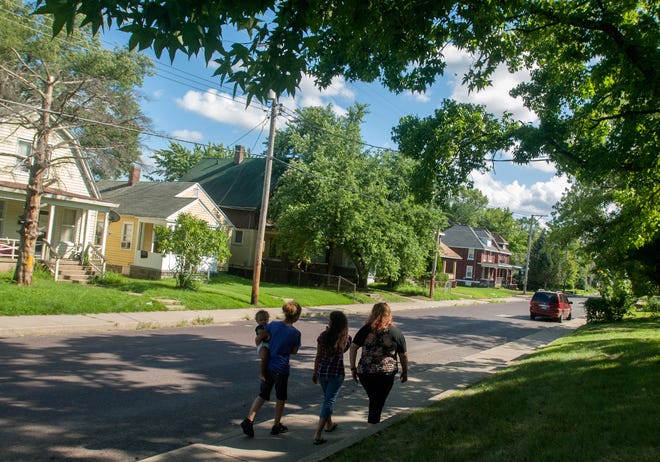 MATT DAYHOFF/JOURNAL STAR Kristen Michaud, left, walks with her daughter Talyn Bullock, middle, and her friend Angelica Ortiz, both 13, on Northeast Madison on the designated safe route approved by Peoria Public Schools for students walking to Lincoln School.