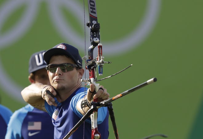Jake Kaminski of the United States releases his arrow during the men's team archery competition Saturday at the Sambadrome venue during the Summer Olympics in Rio de Janeiro, Brazil. Kaminski is a Gainesville resident and trained at the Easton-Newberry Archery Center. (Natacha Pisarenko/The Associated Press)