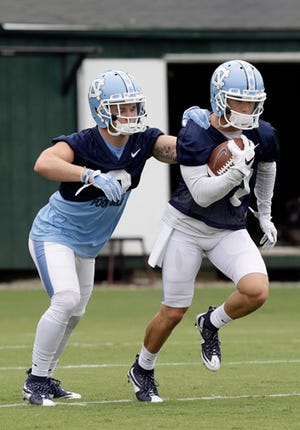 North Carolina receivers Ryan Switzer, left, and Austin Proehl run through a drill during Friday's practice.