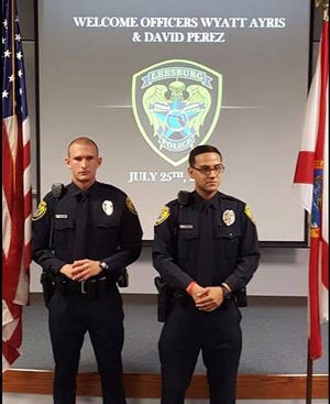 Wyatt Ayris, left, and David Perez pose during their swearing in ceremony on July 25 for the Leesburg Police Department. Ayris was one of three officers who recently left the department, saying he didn't want to be a policeman anymore.