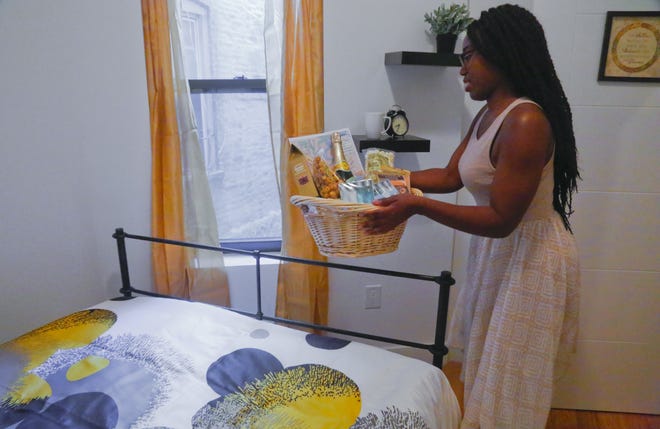 Ashley Warmington, CEO of Cozy Oasis, a short-term rental concierge company, places a welcome basket in the bedroom window of a property that she manages listings for in New York. Warmington is partnering her company's services with the anti-racism lodging website Noirbnb. 





AP Photo/Bebeto Matthews