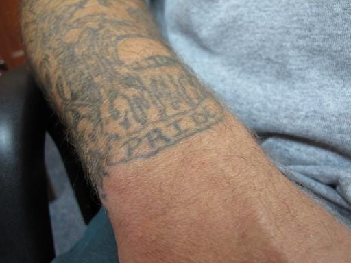 A prison tattoo with the word "PRIDE" stands out from Johnny Small's forearm during an interview at New Hanover Correctional Center in Wilmington, N.C., on Thursday, Aug. 4, 2016. Small is awaiting a hearing on whether his conviction in the 1988 murder of fish store owner Pam Dreher will be overturned. A hearing is scheduled to begin Monday, Aug. 8 for Small, who has always maintained his innocence. The judge could vacate the conviction, order a new trial or uphold the conviction.