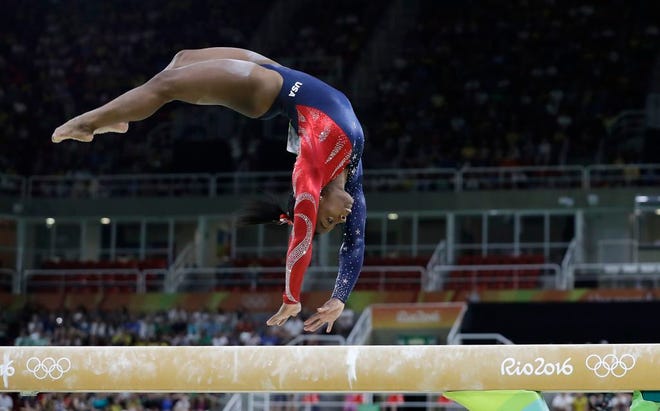 United States' Simone Biles performs on the balance beam during the team gymnastics women's qualification at the 2016 Summer Olympics in Rio de Janeiro, Brazil, Sunday, Aug. 7, 2016.