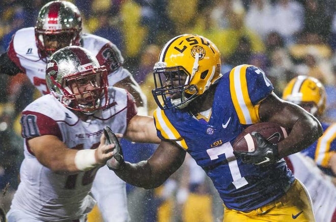 LSU running back Leonard Fournette (7) pushes against Western Kentucky linebacker Nick Holt (10) during an NCAA college football game Saturday, Oct. 24, 2015, in Baton Rouge, La. (Austin Anthony/Daily News via AP) MANDATORY CREDIT