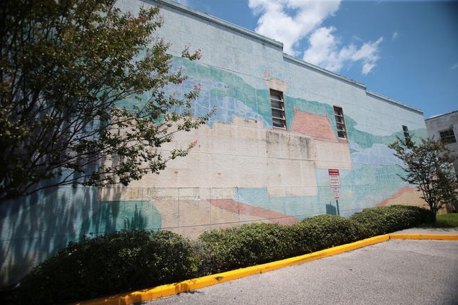 The faded mural of a beach scene on the wall beside the Panama City Center for the Arts is set to be replaced with a new wall design featuring geometric shapes.