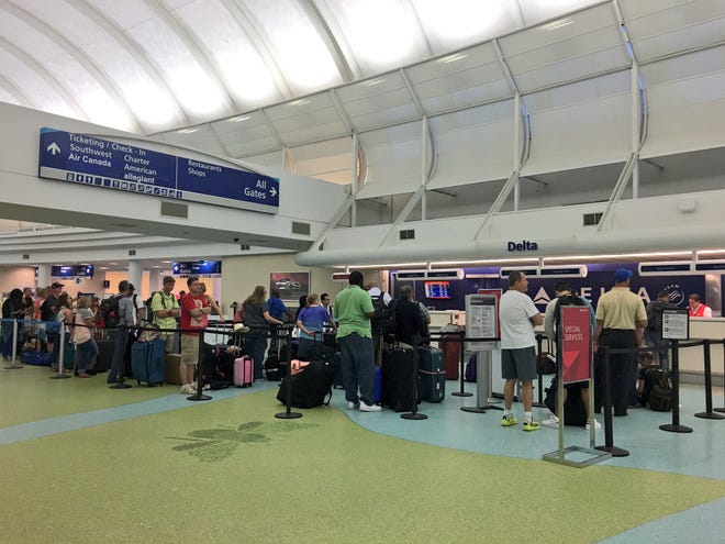 Delta passengers line up at Jacksonville International Airport Tuesday morning.