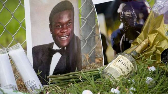 Christo Maccius was killed July 30 outside of O’Connor’s Pub & Package. Friends left mementos and photos the day after at a memorial site at West Boca Raton High School. (Meghan McCarthy / The Palm Beach Post)